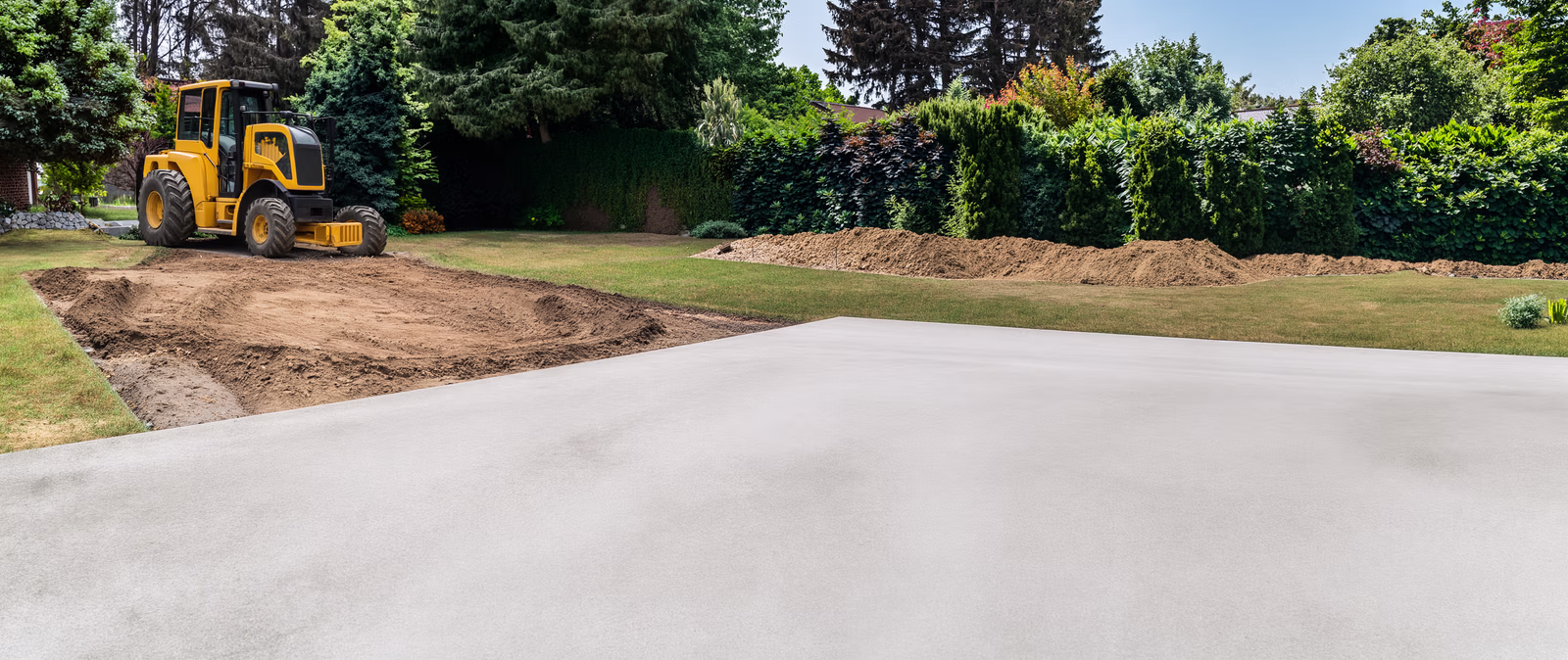 Freshly poured concrete pad foundation by Sandy Creek Construction